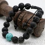 Handmade in Nepal by skilled artisans, this Lava Stone Wrist Mala with turquoise spacer aids emotional grounding and enhances communication, supporting your journey of mindfulness and self-discovery.