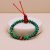 Handmade in Nepal by skilled artisans, this Malachite stone wrist mala with a carnelian spacer promotes spiritual growth and inner peace, guiding you on your journey toward enlightenment.