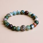 Mantra Bloodstone Wrist Mala, handmade in Nepal by skilled artisans, promotes courage and grounding, enhancing vitality and resilience on your spiritual journey. Wear it to deepen your inner connection.