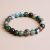 Mantra Bloodstone Wrist Mala, handmade in Nepal by skilled artisans, promotes courage and grounding, enhancing vitality and resilience on your spiritual journey. Wear it to deepen your inner connection.