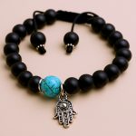 Handmade in Nepal by skilled artisans, this Matte Onyx Stone & Hansa Charm Wrist Mala supports spiritual practice, fostering calm, clarity, and emotional balance on your journey of personal growth.