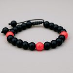 Handmade in Nepal by skilled artisans, this Matte Onyx wrist mala with a Coral spacer embodies grounding energy and emotional stability, enhancing your meditation and daily mindfulness practice.