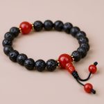Handmade in Nepal by skilled artisans, this Lava Stone Wrist Mala anchors emotions and fosters resilience, serving as a companion for meditation and spiritual growth.