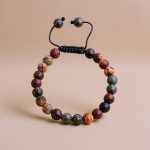 Handmade in Nepal by skilled artisans, this Red Picasso Jasper Stone Wrist Mala fosters emotional balance and creativity, serving as a meaningful companion for personal growth and spiritual practice.