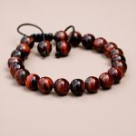 Handmade in Nepal by skilled artisans, this Red Tiger Eye wrist mala embodies spiritual strength and balance, serving as a powerful companion for meditation and mindfulness practices.