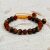 This handmade wrist mala from Nepal combines the protective Rudraksha seed and empowering Tiger Eye stone, fostering spiritual harmony and emotional strength on your journey.