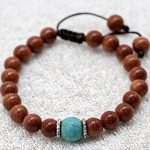 Shining Sun Stone Wrist Mala, handmade by skilled artisans in Nepal, serves as a sacred companion for meditation, fostering inner calm and enhancing communication on your spiritual journey.