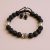 Handmade in Nepal by skilled artisans, this Lava Stone wrist mala features Skull Beads, symbolizing impermanence and offering grounding support for your spiritual journey.