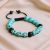 Handmade in Nepal by skilled artisans, this Skull Turquoise Stone Wrist Mala symbolizes communication and self-expression, fostering confidence and spiritual healing in your practice.