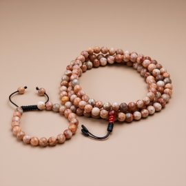 Handmade in Nepal by skilled artisans, this Sun Stone Prayer Mala/Wrist Mala serves as a sacred companion for meditation, fostering joy and connection to the divine.