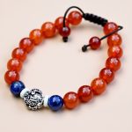 Handmade in Nepal by skilled artisans, this wrist mala features Carnelian and Lapis Lazuli stones, promoting vitality, spiritual awareness, and mindfulness in your practice.