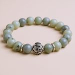 Handmade in Nepal by skilled artisans, this labradorite wrist mala features 22 beads and Tibetan mantra rings, supporting your meditation and mindfulness practices with its transformative energy.
