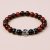 Handmade in Nepal by skilled artisans, this wrist mala features Red Tiger Eye and obsidian, fostering emotional balance and grounding energy for your spiritual journey.