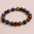 The Tiger Eye Stone Wrist Mala, handmade in Nepal by skilled artisans, offers grounding energy and emotional clarity, supporting your meditation and daily practices with strength and focus.