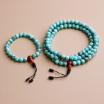 Handcrafted in Nepal by skilled artisans, this Turquoise Stone Prayer Mala and Bracelet Set supports meditation and mindfulness, fostering expressiveness and positivity through its serene gemstones.