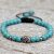 Handmade in Nepal by skilled artisans, this Turquoise Stone Wrist Mala features a white metal skull bead, symbolizing transformation and protection, guiding your spiritual journey with clarity and courage.