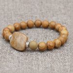 Wood Jasper Stone Wrist Mala, handmade by skilled artisans in Nepal, embodies grounding energy, fostering stability and calmness in your spiritual practice and daily life.