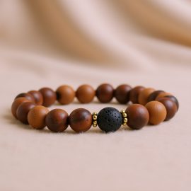 The Bayong Wood Wrist Mala with Lava Stone, handmade in Nepal by skilled artisans, fosters emotional balance and spiritual growth, transforming negative energies into warmth and compassion.