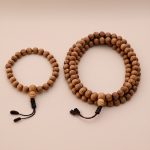 Handmade in Nepal by skilled artisans, this Dark Brown Sandalwood Japa Mala and Wrist Mala/Bracelet Set supports your meditation practice, fostering mindfulness and a deep connection to the Earth.