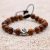 This handmade wrist mala, crafted by skilled artisans in Nepal, features Bayong wood and a sacred Om charm, fostering tranquility and spiritual connection for the wearer.