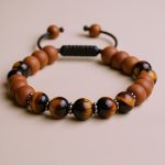 Handmade in Nepal by skilled artisans, this Sandalwood & Tiger Eye Stone Wrist Mala supports mindfulness and meditation, guiding the wearer towards clarity and inner peace.