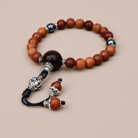 This Tibetan Mantra Bayong Wood Wrist Mala, handmade in Nepal by skilled artisans, aids meditation and mindfulness, fostering calmness and a deeper spiritual connection with each bead.