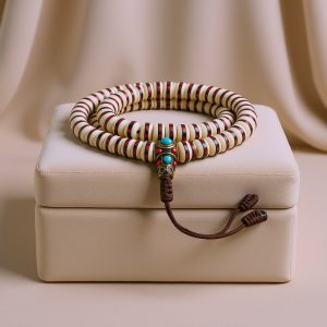 Handmade in Nepal by skilled artisans, this Yak Bone Japa Mala features inlaid brass, symbolizing the cycle of life and serving as a profound aid in meditation and prayer.