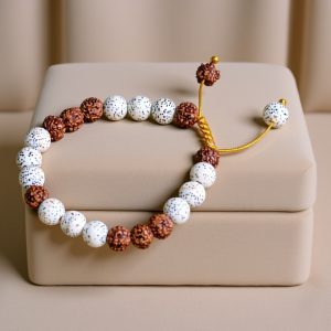The Rudraksha & Lotus Seed Wrist Mala, handmade in Nepal by skilled artisans, symbolizes spiritual awakening and protection. It is a meaningful companion for meditation and inner peace.