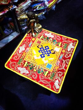 This handmade Tibetan altar cloth, crafted from silk brocade by skilled artisans in Nepal, features the endless knot and lotus, symbolizing life's interconnectedness and enhancing your sacred space.