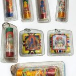 This handmade Tibetan Mantra Healing Amulet, crafted by skilled artisans in Nepal, holds a sacred mantra, inviting peace and positive energy into your life.