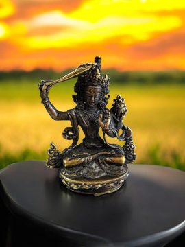 Embrace the wisdom of Tibetan Buddhism with this handmade Manjushri statue, crafted by skilled artisans in Nepal. A cherished companion on your spiritual journey.