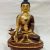 This handmade copper and gold Medicine Buddha statue, crafted by skilled artisans in Nepal, embodies healing and compassion, enhancing one's meditative practice and spiritual journey.
