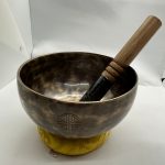 This handmade full moon healing singing bowl from Nepal, crafted with eight sacred metals, enhances meditation and relaxation, guiding practitioners toward inner peace. It includes a cushion and beater stick.