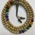 This handmade mala, crafted in Nepal by skilled artisans, features 108 lotus seed beads and seven chakra prayer beads, symbolizing the harmony of spiritual and earthly energies.