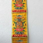 This handmade yellow silk brocade letter holder from Nepal features the Eight Lucky Symbols, bringing blessings and harmony to your home or office while organizing your essentials.