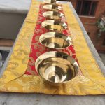 This set of seven handmade brass water offering bowls from Nepal enhances your shrine, embodying the practice of generosity and nurturing for all sentient beings in Vajrayana Buddhism.