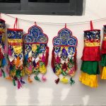 These handmade temple hangings from Nepal, crafted by skilled artisans, embody the essence of Tibetan Buddhism, enhancing sacred spaces with their lotus design, symbolizing purity and enlightenment.