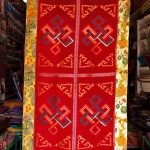 This handmade silk brocade Tibetan table cover, crafted by skilled artisans in Nepal, features the Endless Knot, symbolizing life's interconnectedness and enhancing your spiritual practice.