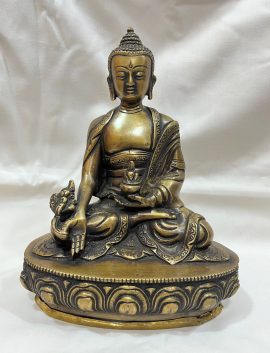 Handmade in Nepal by skilled artisans, this brass and bronze Medicine Buddha statue embodies healing and compassion, serving as a spiritual guide for alleviating suffering through meditation.