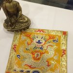 This handmade Tibetan silk brocade placemat, featuring a dragon, embodies strength and protection, creating a sacred space for your meditation practice. Crafted by skilled artisans in Nepal.
