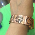 This handmade 7 chakra copper bracelet, crafted by skilled artisans in Nepal, encourages balance and mindfulness, inviting the wearer to connect with their inner energy and the universe.