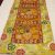 This handmade Tibetan table runner from Nepal, adorned with a double dorje symbol and floral border, enriches your meditation space with its spiritual essence and vibrant design.