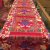 This handmade Tibetan silk brocade table runner, crafted by skilled artisans in Nepal, features the endless knot, symbolizing interconnectedness, perfect for enhancing your meditation space.