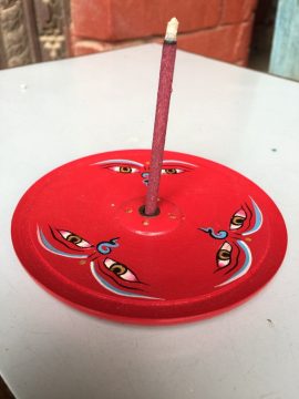 This handmade wooden incense burner, crafted by skilled artisans in Nepal, features the serene Buddha eyes design, inviting wisdom and compassion into your meditation practice.