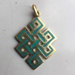 This handmade Endless Knot pendant, crafted by skilled artisans in Nepal, symbolizes the interconnectedness of wisdom and compassion in Vajrayana Buddhism, reflecting the infinite nature of existence.