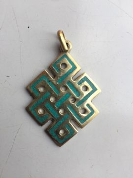This handmade Endless Knot pendant, crafted by skilled artisans in Nepal, symbolizes the interconnectedness of wisdom and compassion in Vajrayana Buddhism, reflecting the infinite nature of existence.