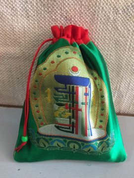 This handmade kalachakra mala bag, crafted in Nepal by skilled artisans, protects your mala and enriches your spiritual practice, serving as a versatile companion on your journey.