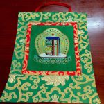 This handmade silk brocade wall hanging, crafted in Nepal, features the sacred Kalachakra, symbolizing time and enlightenment, inviting deep reflection and devotion in your spiritual space.