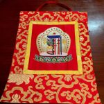 This handmade silk brocade wall hanging from Nepal features the sacred Kalachakra, embodying the teachings of compassion and enlightenment, perfect for enriching your spiritual space.