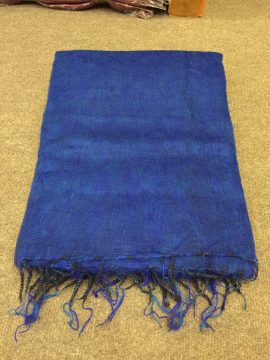 This blue yak wool meditation shawl, handmade in Nepal by skilled artisans, envelops you in warmth, enhancing focus and mindfulness during your spiritual practice.
